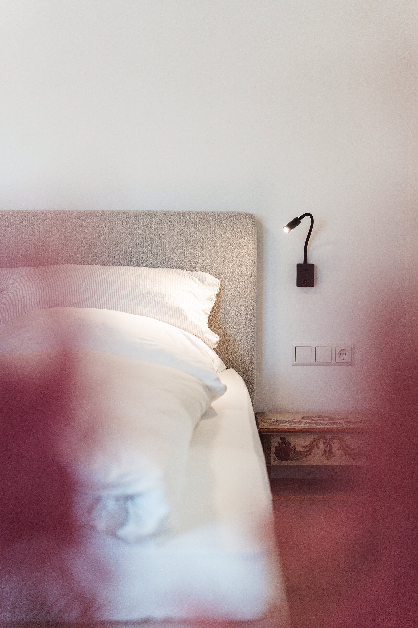 Schlafzimmer im Gästehaus mit bequemen Bett und moderner Beleuchtung.